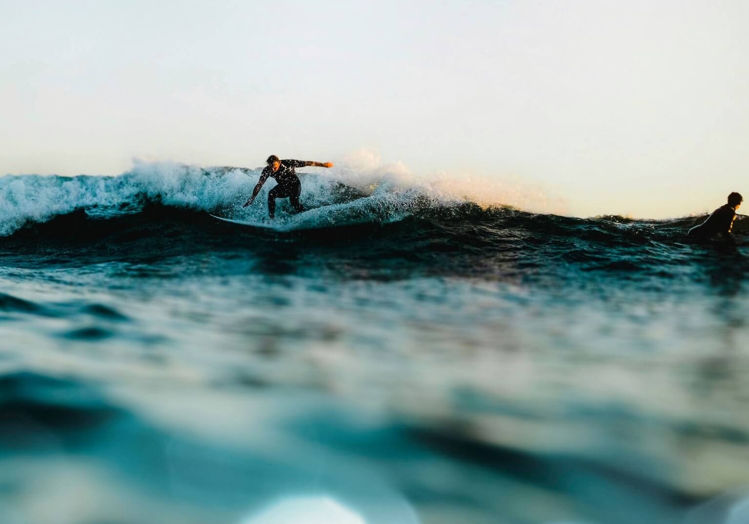 Man balancing on shifting waves, representing the uncertainty that can come with freedom.